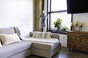 a living room with a couch and a dresser at Urban Loft Apartment in Los Angeles