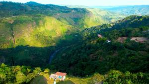 an aerial view of a mountain valley with a waterfall at Hotel Kasama in San Agustín