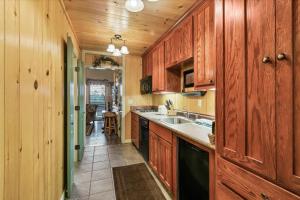 a kitchen with wooden cabinets and a sink and a counter at Seventh Mountain 1031 condo in Bend