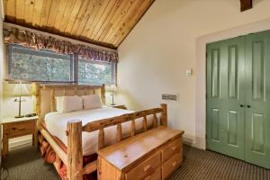 a bedroom with a wooden bed and a green door at Seventh Mountain 1031 condo in Bend