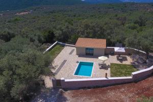 an aerial view of a house with a swimming pool at Lefkolia Retreat in Sivota