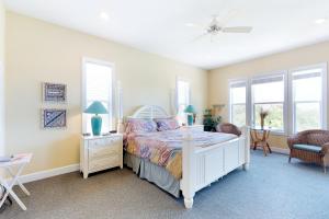 a bedroom with a bed and two windows and a ceiling fan at Abbeyfeale in St. George Island +21 photos