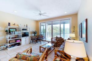 a living room with a couch and a tv at Abbeyfeale in St. George Island