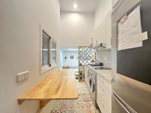 a kitchen with a wooden counter top and a refrigerator at Ile Atocha Exterior Olivar in Madrid
