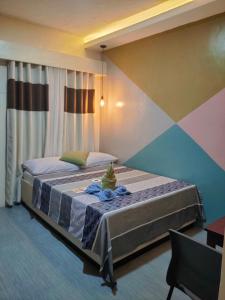 a bedroom with two beds and a colorful wall at NINIE'S PLACE in Puerto Princesa City