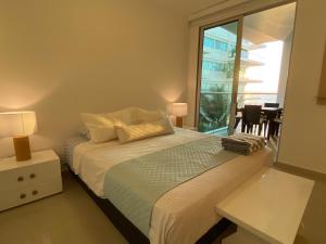 a bedroom with a bed and a large window at Apartamento en Cartagena con vista al mar in Cartagena de Indias