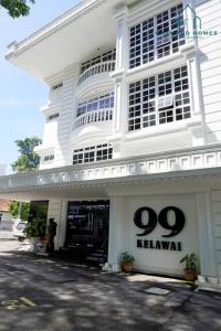 a white building with a sign on the front of it at 99 Kelawei in George Town