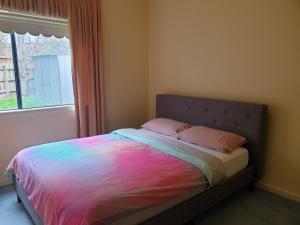 a bed in a bedroom with a window at Vacation Getaway in Rowville
