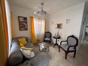 a living room with a couch and two chairs at Colimar in San Felipe de Puerto Plata
