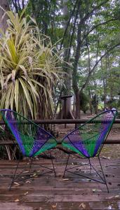 un par de sillas sentadas en una terraza de madera en Maya Internacional, en Flores