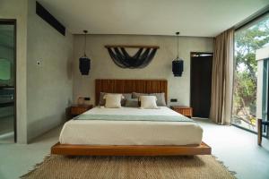 Postel nebo postele na pokoji v ubytování Villa Xuncari en el corazón de la selva Tulum