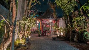 an alley with potted plants in a building at night at Budarno Homestay in Yogyakarta