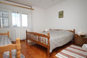 a bedroom with a bed and a dresser and windows at Apartments with parking space Zavala, Hvar - 8802 in Zavala