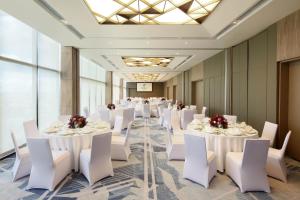 a banquet hall with white tables and white chairs at Holiday Inn Cebu City, an IHG Hotel in Cebu City