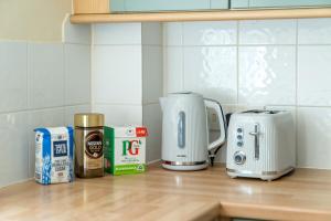 a kitchen counter with a toaster and a coffee maker at Redhill Surrey 2 Bedroom Pet Friendly Apartment by Sublime Stays in Redhill