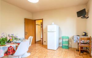 eine Küche mit einem Tisch und einem weißen Kühlschrank in der Unterkunft Alloro 2 in Montecarlo