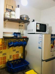a kitchen with a refrigerator and a microwave on top of it at Casa Calo Bialet Massé in Bialet Massé