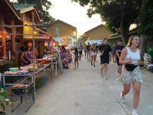 a group of people walking down a street at Boy Scouts Homestay in Ban Nua