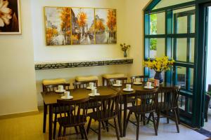 a dining room with a table and chairs at Elene Phu Quoc in Phu Quoc
