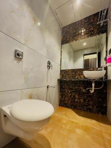 a bathroom with a toilet and a sink at Hotel lime wood in Mumbai