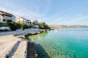 a view of a body of water with buildings at Holiday home Villa Linda - big terraces in Seget Vranjica