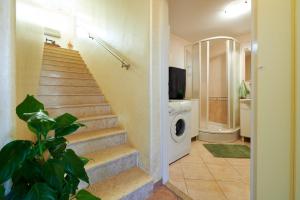 a bathroom with a staircase and a washing machine at Holiday home Villa Linda - big terraces in Seget Vranjica