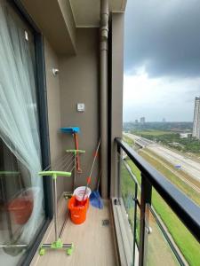 a balcony with a view of a train at Precious Angel Apartment Sky House BSD in Pagedangan
