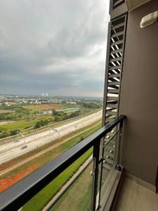 a balcony with a view of a highway at Precious Angel Apartment Sky House BSD in Pagedangan