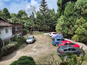 a group of parked cars parked in a yard at Hotel Mhelung in Darjeeling