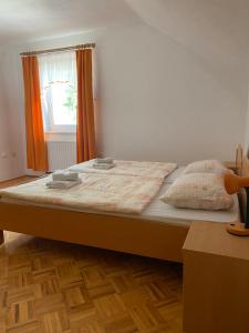 a large bed in a room with a window at KMETIJA KNAVS in Nova Vas