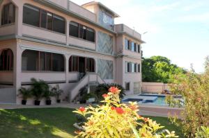 a building with a swimming pool in front of it at Vision with Dreams VIlla in Runaway Bay