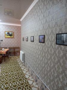 a room with a wall covered in wallpaper at LION Guest House in Bukhara