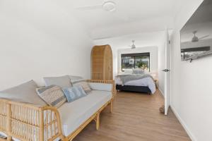 a living room with a couch and a bed at Bella Vita by Experience Jervis Bay in Vincentia
