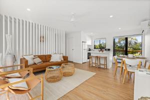 a living room with a couch and a table at Bella Vita by Experience Jervis Bay in Vincentia