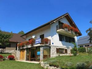 a building with flower boxes on the front of it at House Draga Plitvice near the lakes and bus stop in Plitvička Jezera