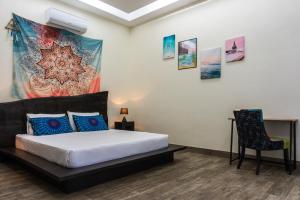 a bedroom with a bed and a chair at LUXURY VILLA ELENA with POOL not far from Lio beach in El Nido