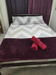 a bed with two towels on top of it at CiTY Roomstay Budget Midtown Kuala Terengganu 2queen beds in Kuala Terengganu