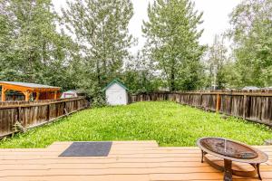 a backyard with a wooden fence and a wooden table at Keyann Circle in Anchorage