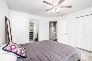 a bedroom with a bed and a ceiling fan at Keyann Circle in Anchorage