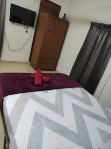a bedroom with a bed with a red object on it at CiTY Roomstay Budget Middle Kuala Terengganu 1queen bed in Kuala Terengganu
