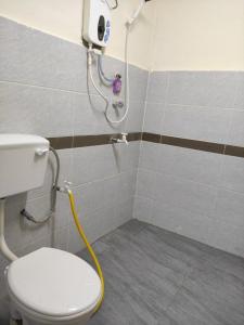 a bathroom with a white toilet and a shower at CiTY Roomstay Budget Middle Kuala Terengganu 1queen bed in Kuala Terengganu