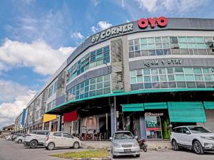a building with cars parked in front of it at OYO 89840 69 Room 4 Stay in Sibu