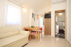 a living room with a couch and a table at Apartments by the sea Valun, Cres - 8086 in Valun