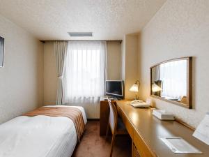 Tabist Abashiri Central Hotel客房内的一张或多张床位