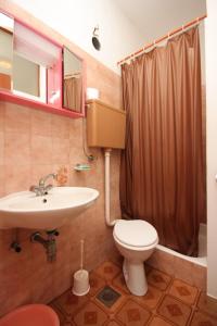 a bathroom with a toilet and a sink and a shower at Twin Room Luka 8132e in Žman