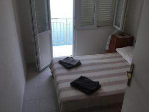 a bedroom with two beds with black towels on them at Apartment Savar 8079c in Brbinj