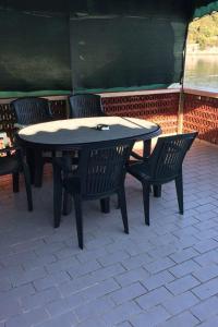 a table and chairs sitting on a patio at Apartment Savar 8079c in Brbinj