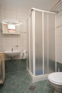 a bathroom with a shower and a sink and a toilet at Apartment Mali Losinj 8090c in Mali Lošinj
