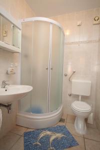a bathroom with a shower and a toilet and a sink at Apartments with a parking space Mali Losinj (Losinj) - 8090 in Mali Lošinj