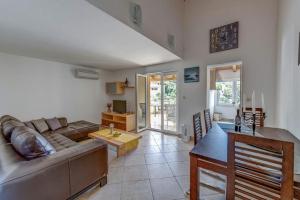 a living room with a couch and a table at Apartments by the sea Savar, Dugi otok - 8128 in Brbinj